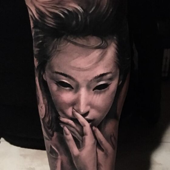 Black and grey realistic tattoo of a beautiful female face - arm sleeve tattoo