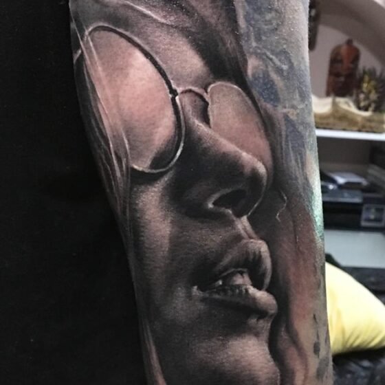 Black and grey realistic tattoo of a beautiful female face - arm sleeve tattoo