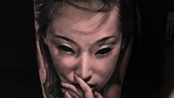 Striking Black and Gray Realism Tattoo: Portrait and Hands Design